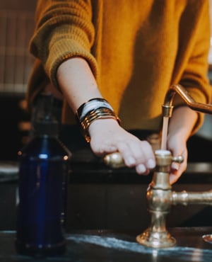 Woman washing at the sink | Facets Singapore
